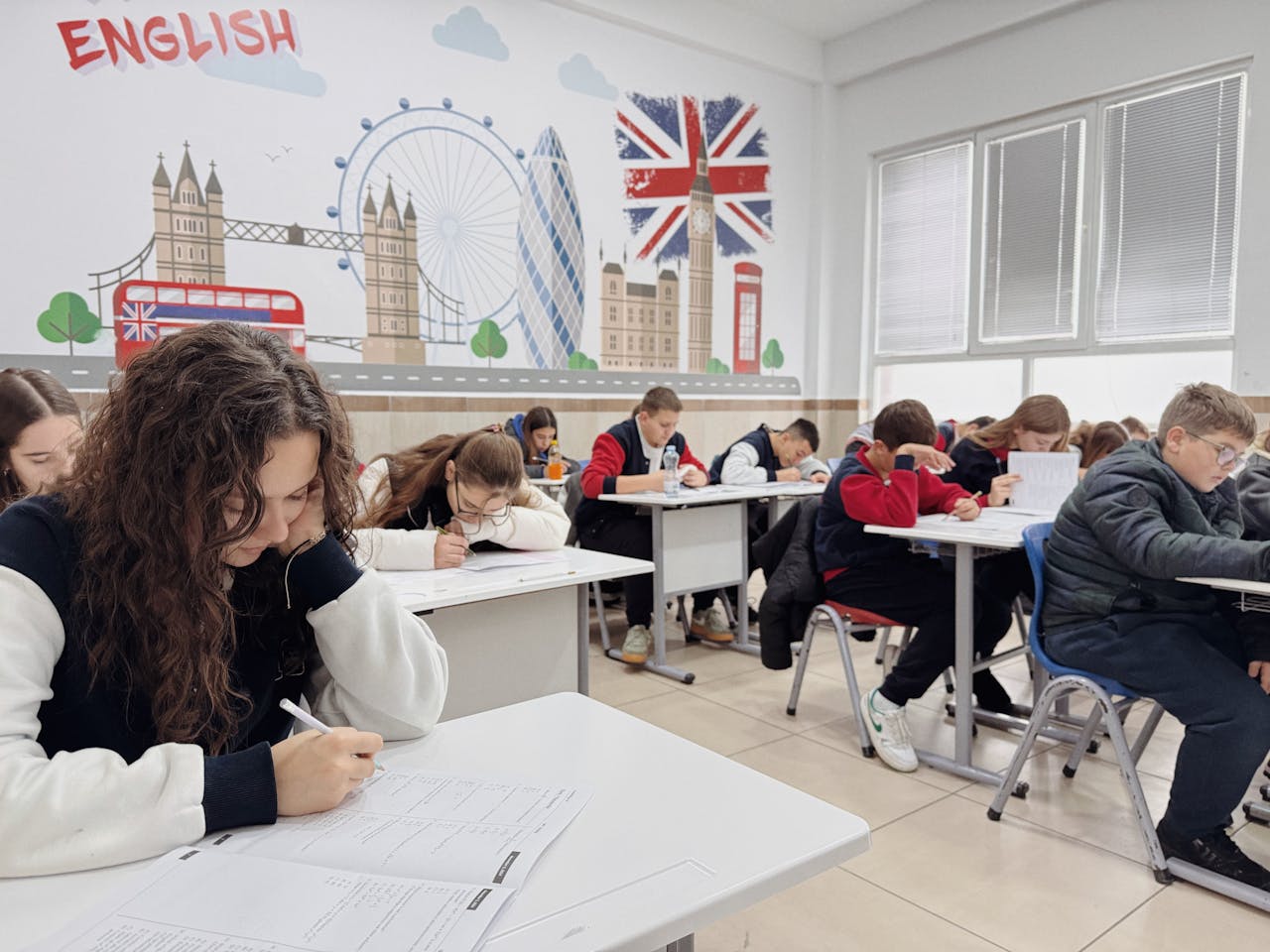 our-experience Students focus on an English class study session in a London-themed classroom.